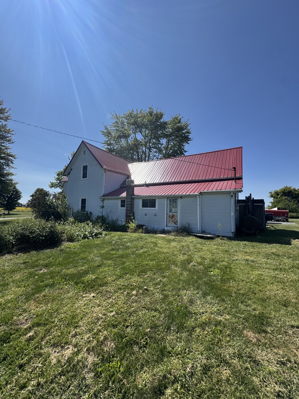 Farmhouse with a Windy Hill red metal roof
